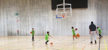 Children playing basketball on the school court